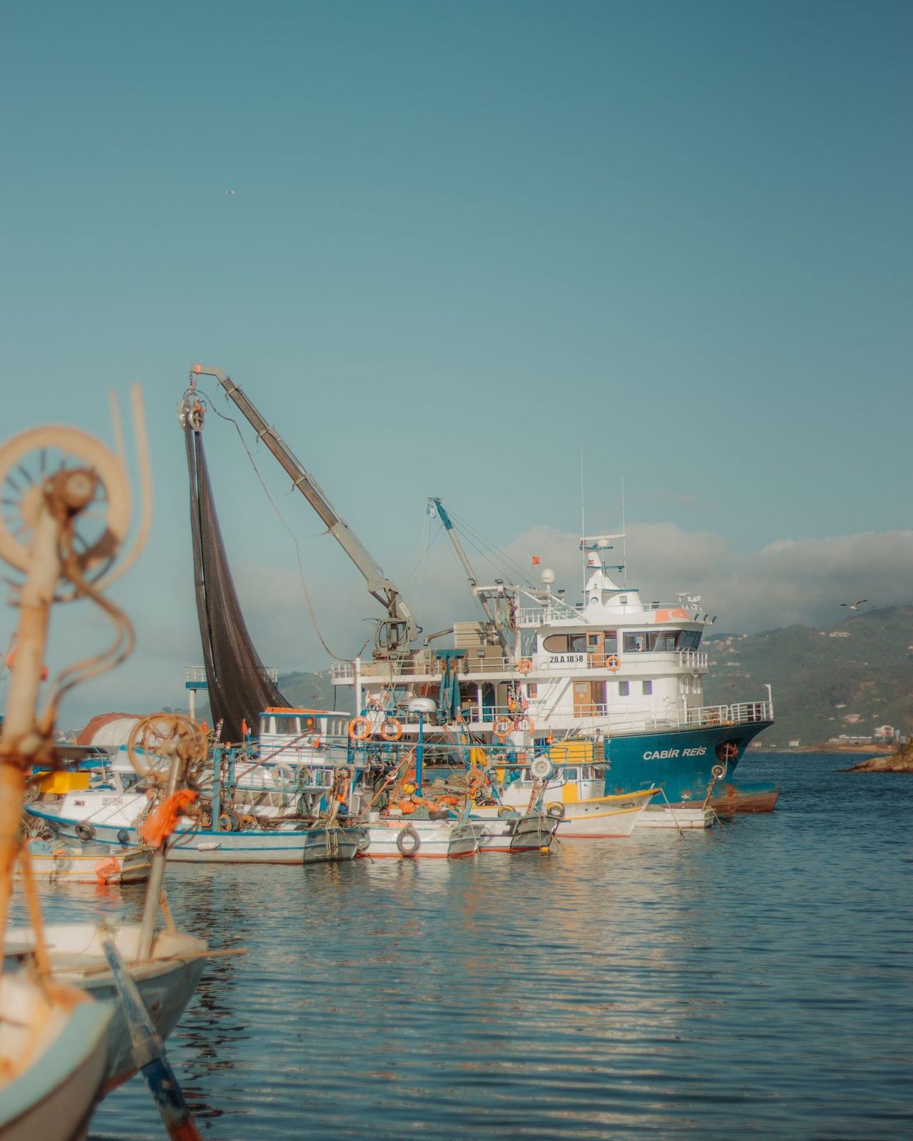 Boats moored along a harbour wall